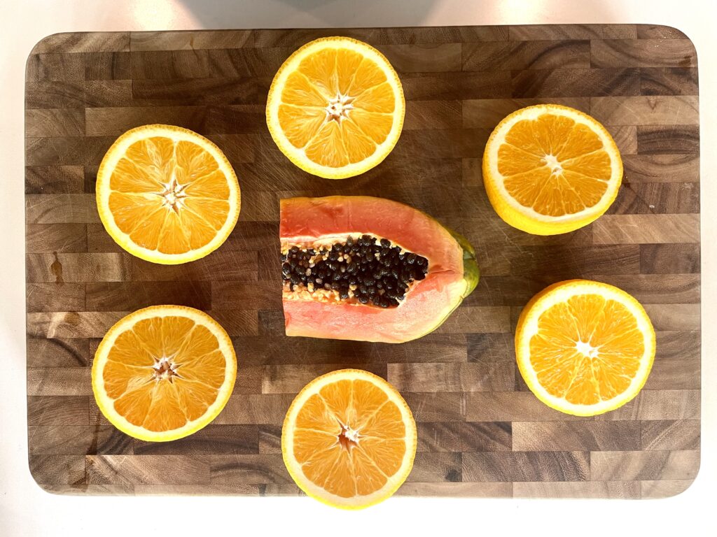 Papaya and Orange on a cutting board