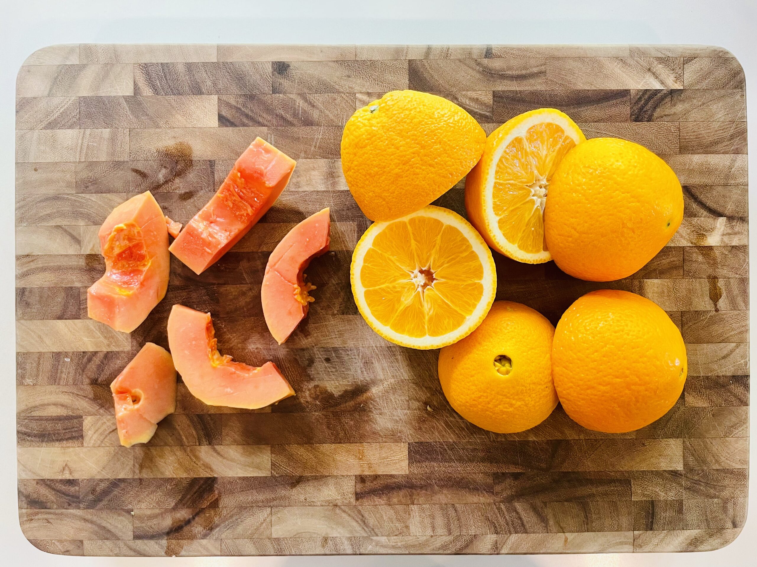 orange and papaya on a board